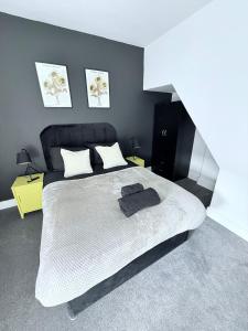 a bedroom with a large white bed with two pillows at Seaside Home - Spacious Rooms - TV's in Every Room in Cleethorpes