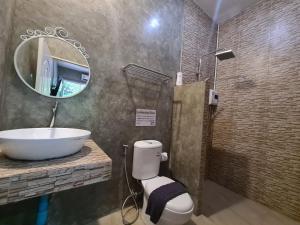 a bathroom with a sink and a toilet and a mirror at Samed Your House in Ko Samed +69 photos