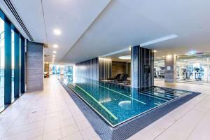 a large swimming pool in the middle of a building at Opulent Harbourside Sanctuary in Melbourne