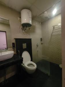 a bathroom with a toilet and a sink at Jolly Luxury Resort in Gangtok +11 photos