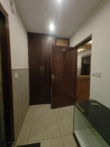 an empty room with a door and a mirror at Jolly Luxury Resort in Gangtok