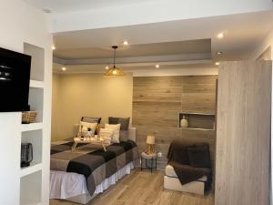 a bedroom with a large bed and a couch at Studio t1 in Mornas