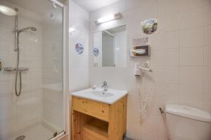 a bathroom with a sink and a shower and a toilet at Epicéa Lodge Hôtel et Camping in Pralognan-la-Vanoise +34 photos