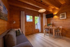 a living room with a couch and a table at Apartments Schlossblick Naturholz in Vols am Schlern