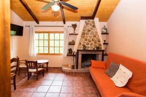 a living room with a couch and a fireplace at casarural lapandera in Los Villares