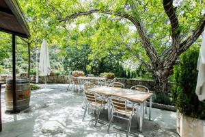 a patio with tables and chairs and an umbrella at casarural lapandera in Los Villares