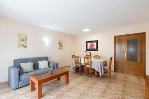 a living room with a couch and a table at Apartamentos MARE INTERNUM III La Pineda in La Pineda