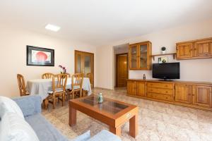 a living room with a couch and a table at Apartamentos MARE INTERNUM III La Pineda in La Pineda