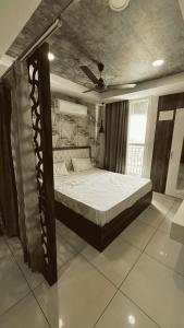 a bedroom with a bed in a room with a ceiling at The Cove in Zirakpur