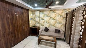 a living room with a couch and a wall at The Cove in Zirakpur +3 photos