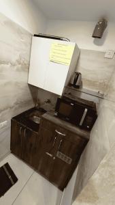 a kitchen with a sink and a box on the wall at The Cove in Zirakpur