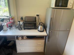 a kitchen with a microwave and a refrigerator at Ruapehu country lodge in Ohakune
