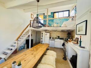 a loft conversion with a wooden bench in a kitchen at Maison Nomade, Clim - Terrasse in Arles