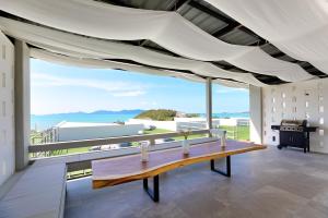 a dining room with a table and a view of the ocean at Massive 4 Bedroom with Cinema Room and Gym in Koh Samui 