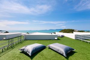 two pillows on the roof of a house at Massive 4 Bedroom with Cinema Room and Gym in Koh Samui 