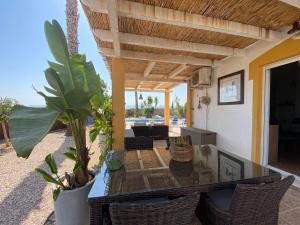 a dining room with a glass table and chairs at Casa Vida La Vida in Mazarrón