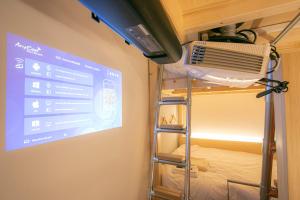 a room with a projection screen and a bunk bed at Theatel Sapporo in Sapporo