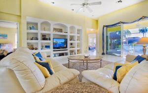 a living room with a white couch and a table at Villa Viscaya in Shell Point Village