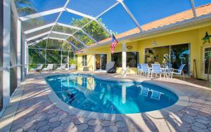 a swimming pool in the backyard of a house at Villa Viscaya in Shell Point Village