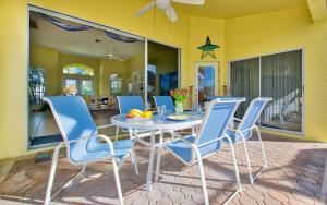 a dining room with a table and blue chairs at Villa Viscaya in Shell Point Village