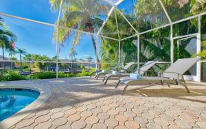 a group of chairs sitting next to a swimming pool at Villa Viscaya in Shell Point Village +20 photos