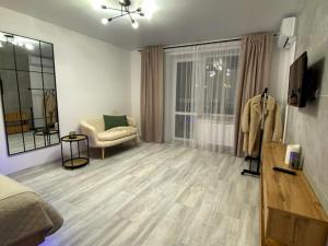 a living room with a couch and a chair at Comfort House Партизанська 25 in Bila Tserkva