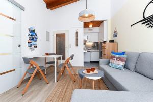 a living room with a couch and a table at Ferienwohnung Happynest in Bensersiel +17 photos