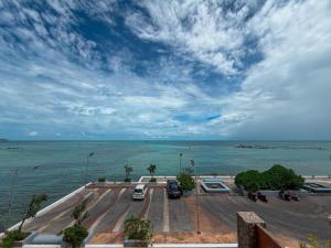 a view of the ocean with cars parked in a parking lot at ClayHouse SAMUI Boutique Hotel in Koh Samui