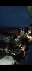 a view of a city at night with lights at Nature Retreat in Gangtok
