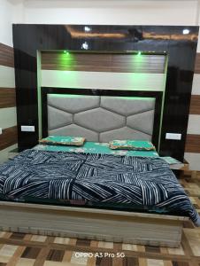 a bed with a black and white comforter at HOTEL sHIV STAY in Katra +11 photos