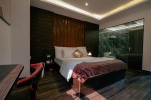 a hotel room with a bed and a shower at Love in the Atlantis Hotel in Hanoi