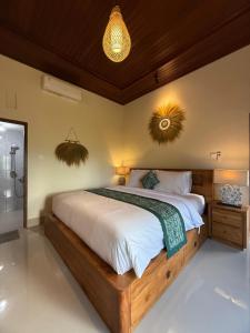 a bedroom with a wooden bed in a room at D'Labake Guest House in Sidemen