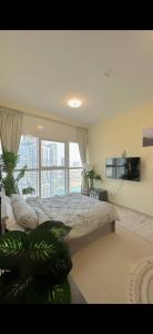 a bedroom with a large bed and a large window at Stay with a wonderful view in Abu Dhabi