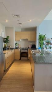 a kitchen with a sink and a stove at Stay with a wonderful view in Abu Dhabi