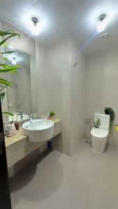a bathroom with a sink and a toilet and a mirror at Stay with a wonderful view in Abu Dhabi
