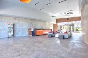 a man standing in a large room with couches at Massive 4 Bedroom with Cinema Room and Gym in Koh Samui  +71 photos