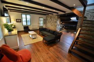 a living room with a couch and a table at Les Coumayres in Riols