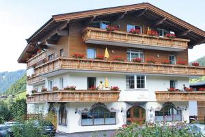 a large building with balconies and flowers on it at Vicky Apartments, Wildschönau-Niederau in Niederau