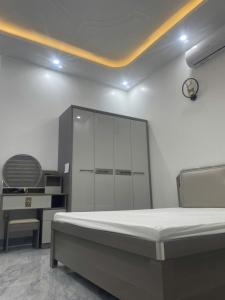 a bedroom with a large bed and a desk at Phu Long Mermaids Hostel 1 in Phù Long