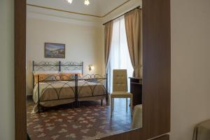 Posteľ alebo postele v izbe v ubytovaní B&B Palazzo Tornabene
