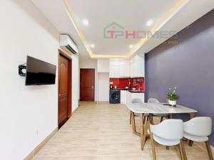 a dining room with a table and chairs and a kitchen at TPHomes Mystery in Ho Chi Minh City
