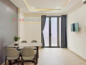 a dining room with a table and chairs at TPHomes Mystery in Ho Chi Minh City +1 photo