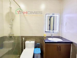 a bathroom with a toilet and a sink at TPHomes Mystery in Ho Chi Minh City