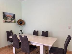 a wooden table and chairs in a room at Ferienwohnung Otto der Reiche in Ballenstedt in Ballenstedt