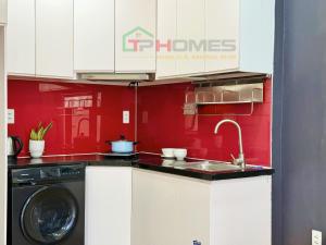 a kitchen with a sink and a washing machine at TPHomes Mystery in Ho Chi Minh City