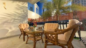 a balcony with chairs and a glass table and a tableablish at Luxurious Al Danah 5BR Family Friendly Getaway in Abu Dhabi