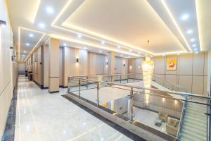 a hallway of a building with a staircase and a room at Gomini Stay in Cebongan