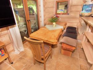 a small room with a wooden table and chairs at Family log cabin in the Alps in Ruhpolding