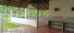 an empty room with a bench in a building with windows at Thota'dha Tent Stay in SanivÄrsante