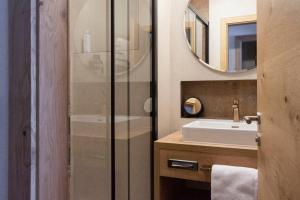 a bathroom with a shower and a sink at Hotel Garni Lawens in Serfaus +38 photos